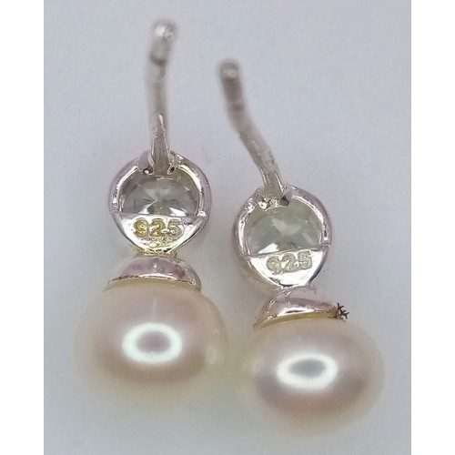 1230 - A fancy pair of 925 silver Zirconia and pearl earrings. Total weight 1.35G.