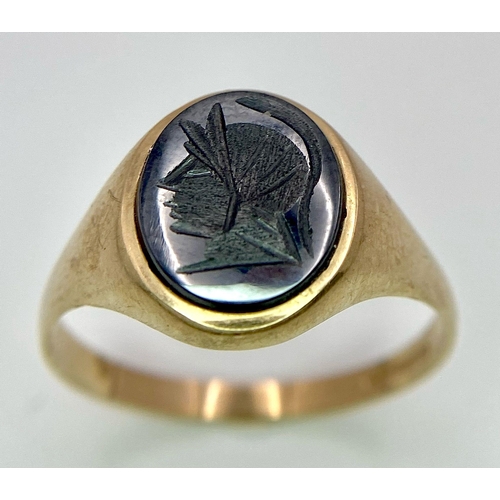 17 - A Vintage 9K Yellow Gold Onyx Signet Ring. Carved centurion decoration. Size T. 3g total weight.