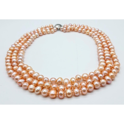 227 - A fashionable three strand of high quality, natural pink pearls necklace, bracelet and earrings set ... 