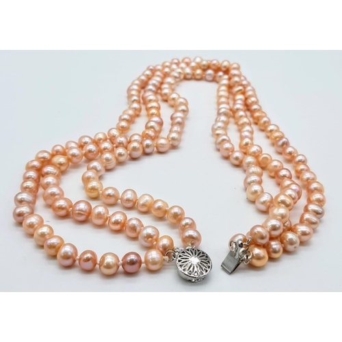 227 - A fashionable three strand of high quality, natural pink pearls necklace, bracelet and earrings set ... 