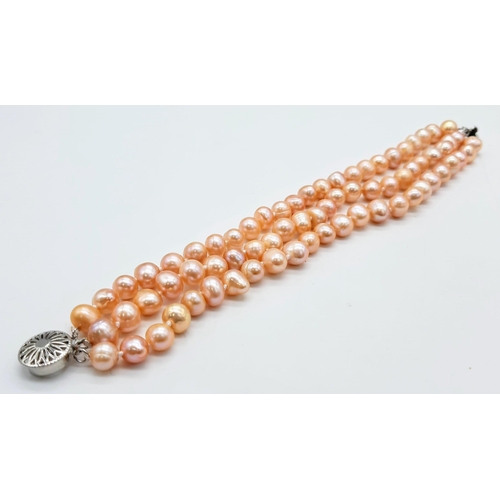 227 - A fashionable three strand of high quality, natural pink pearls necklace, bracelet and earrings set ... 