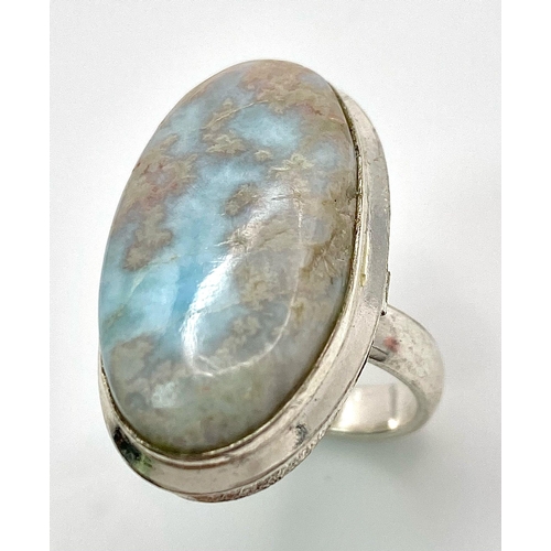 234 - A sterling silver ring with a large (30 x 16 x 5 mm) LARIMAR cabochon, presented in beautiful miniat... 