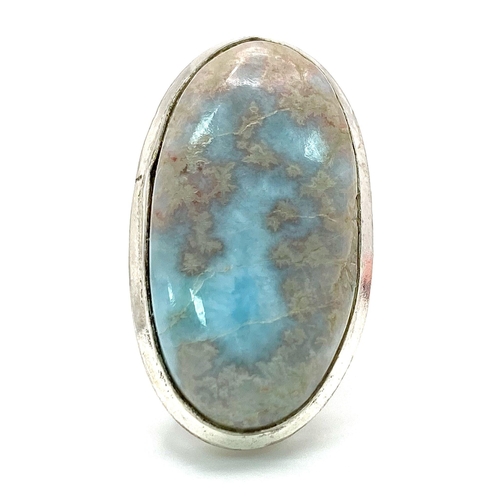 234 - A sterling silver ring with a large (30 x 16 x 5 mm) LARIMAR cabochon, presented in beautiful miniat... 