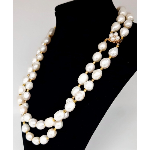 241 - A very desirable, two strand white, natural pearl necklace in an unusual design, adorned with a 9 K ... 