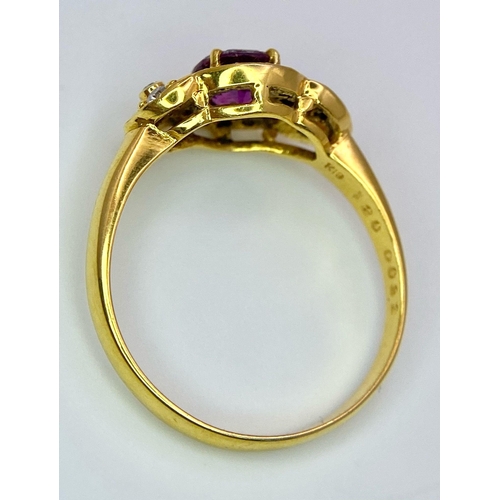 45 - An 18K Yellow Gold Pink Sapphire and Diamond Ring. Central oval sapphire with diamond halo and diamo... 