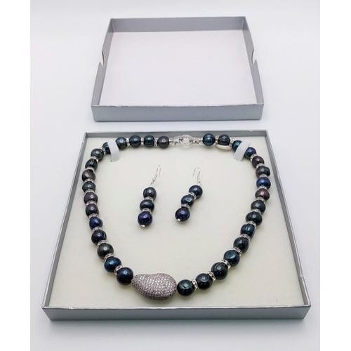 213 - A glamorous Tahitian, black pearl necklace and earrings set highlighted with cubic zirconia. Large 1... 