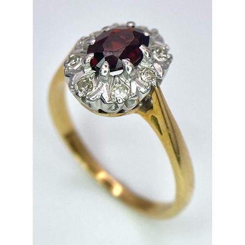 148 - An 18K Yellow Gold Garnet and Diamond Ring. Central oval garnet with diamond surround. Size K. 3.2g ... 