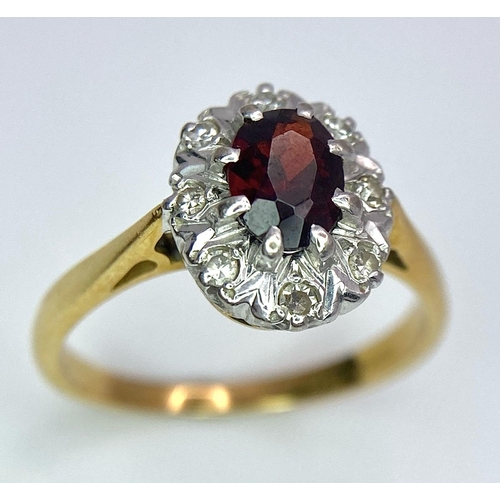 148 - An 18K Yellow Gold Garnet and Diamond Ring. Central oval garnet with diamond surround. Size K. 3.2g ... 