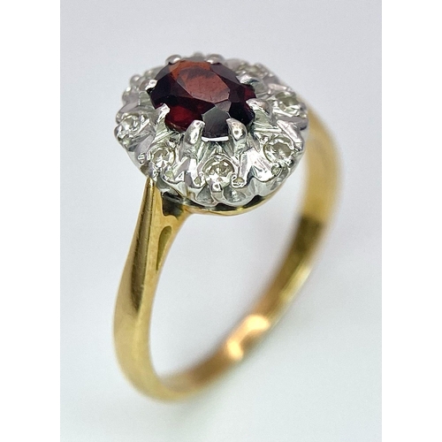 148 - An 18K Yellow Gold Garnet and Diamond Ring. Central oval garnet with diamond surround. Size K. 3.2g ... 