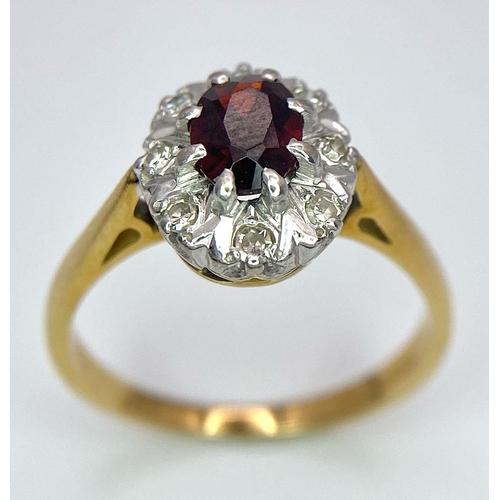 148 - An 18K Yellow Gold Garnet and Diamond Ring. Central oval garnet with diamond surround. Size K. 3.2g ... 