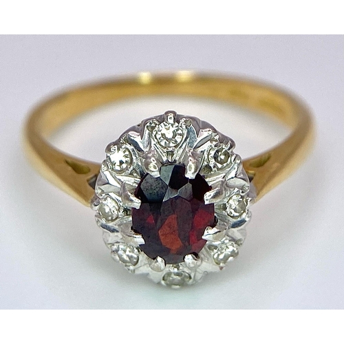 148 - An 18K Yellow Gold Garnet and Diamond Ring. Central oval garnet with diamond surround. Size K. 3.2g ... 