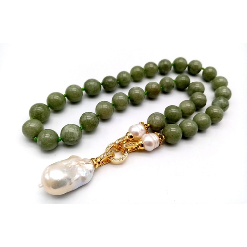 449 - A Keisha Baroque Pearl Pendant on a Pale Green Jade Necklace. White stone accents and gilded clasp. ... 