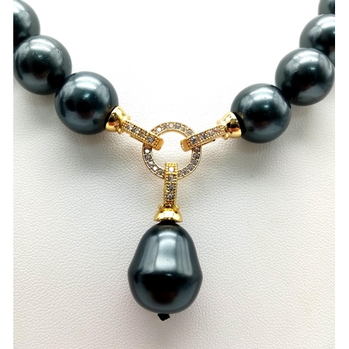 519 - A Metallic Dark Grey South Sea Pearl Shell Necklace with a Teardrop Pendant. 14mm large beads. Gilde... 