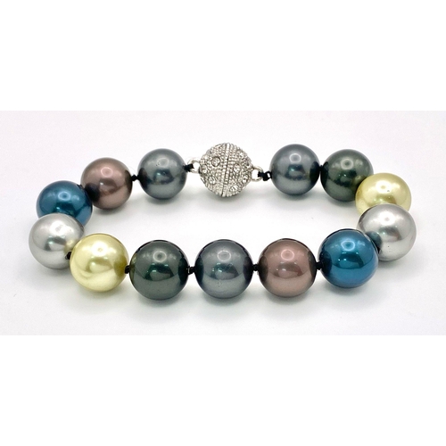 912 - A Multi-Coloured South Sea Pearl Shell Bracelet. 14mm beads. Glitterball magnetic clasp.