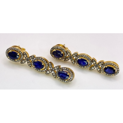 260 - A Pair of Blue Sapphire and Diamond Drop Earrings. Set in gilded 925 Silver. Sapphire ovals - 8ctw a... 