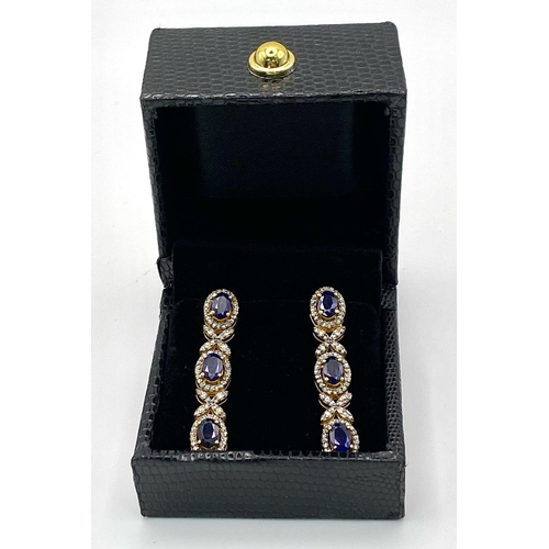 260 - A Pair of Blue Sapphire and Diamond Drop Earrings. Set in gilded 925 Silver. Sapphire ovals - 8ctw a... 