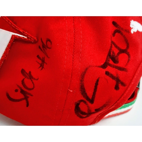 394 - An Official Ferrari Team Cap - Over 20 signatures including Ferrari drivers and team principals. Ple... 