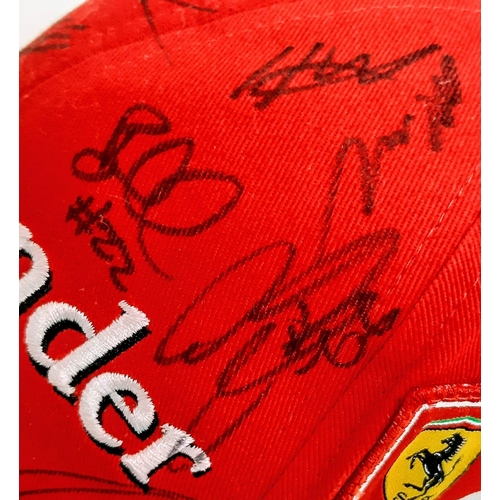 394 - An Official Ferrari Team Cap - Over 20 signatures including Ferrari drivers and team principals. Ple... 