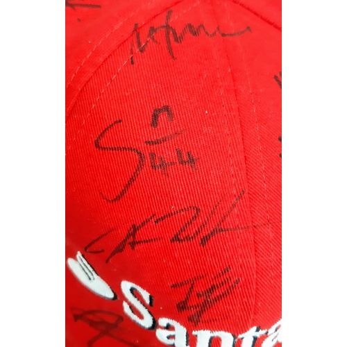 394 - An Official Ferrari Team Cap - Over 20 signatures including Ferrari drivers and team principals. Ple... 