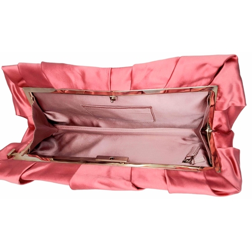 1296 - A Prada Pink Pleated Clutch Bag. Satin exterior with silver-toned hardware and press lock closure to... 