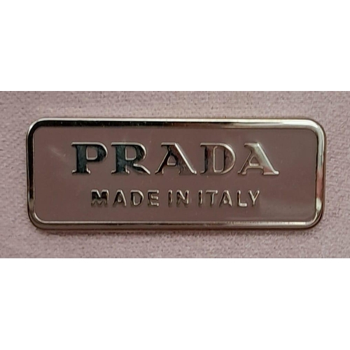 1296 - A Prada Pink Pleated Clutch Bag. Satin exterior with silver-toned hardware and press lock closure to... 