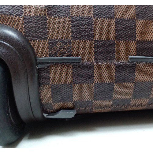 739 - A Louis Vuitton Damier Ebene Eole Convertible Travel Bag. Leather exterior with gold-toned hardware,... 