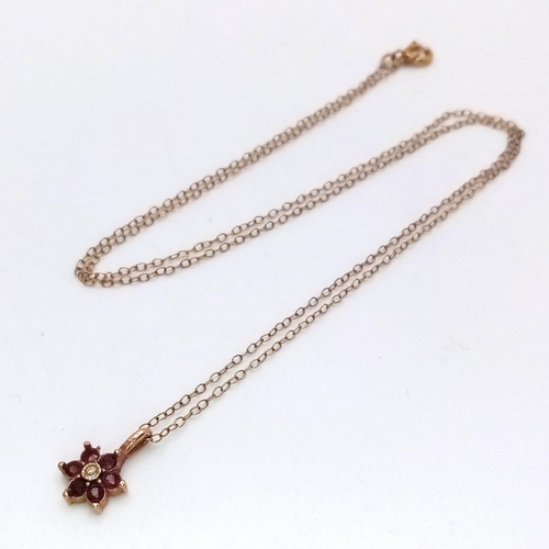 709 - A 9K Yellow Gold Ruby and Diamond Small Floral Pendant on a 9K Yellow Gold Disappearing Necklace. Pe... 