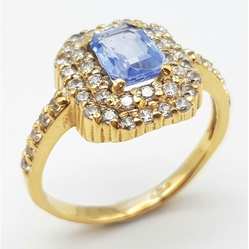 1563 - An Impressive 22K Yellow Gold Sapphire and Diamond Ring. 1ct pale blue central emerald cut sapphire ... 