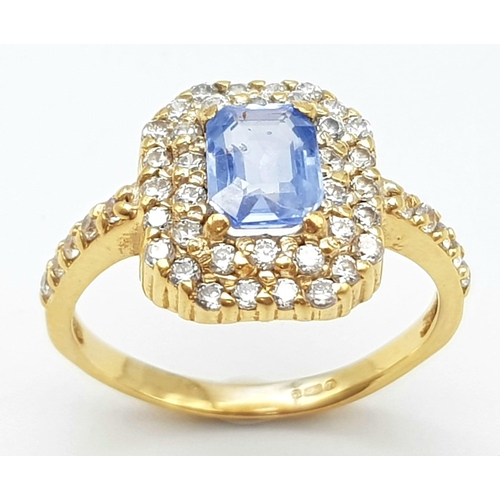 1563 - An Impressive 22K Yellow Gold Sapphire and Diamond Ring. 1ct pale blue central emerald cut sapphire ... 