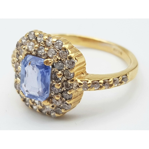 1563 - An Impressive 22K Yellow Gold Sapphire and Diamond Ring. 1ct pale blue central emerald cut sapphire ... 