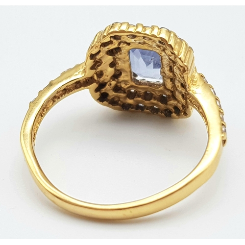 1563 - An Impressive 22K Yellow Gold Sapphire and Diamond Ring. 1ct pale blue central emerald cut sapphire ... 