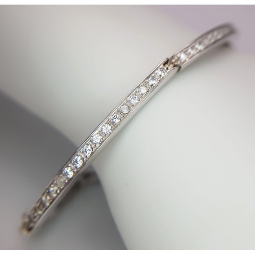 126 - A 14K WHITE GOLD AND DIAMOND SECTIONED BRACELET WITH SAFETY CATCH  .   13.8gms