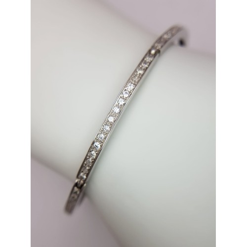 126 - A 14K WHITE GOLD AND DIAMOND SECTIONED BRACELET WITH SAFETY CATCH  .   13.8gms