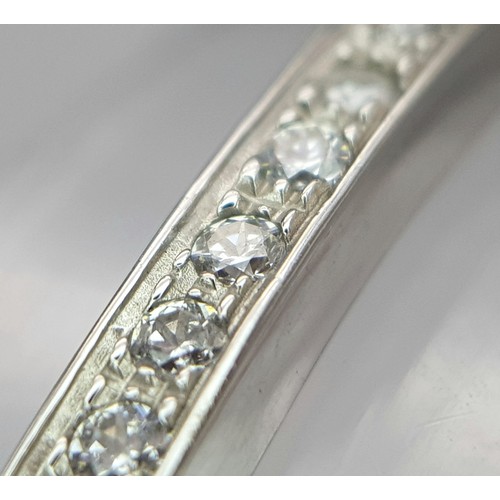 126 - A 14K WHITE GOLD AND DIAMOND SECTIONED BRACELET WITH SAFETY CATCH  .   13.8gms