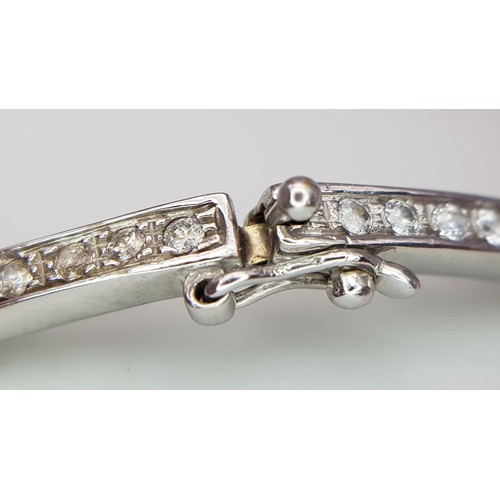 126 - A 14K WHITE GOLD AND DIAMOND SECTIONED BRACELET WITH SAFETY CATCH  .   13.8gms