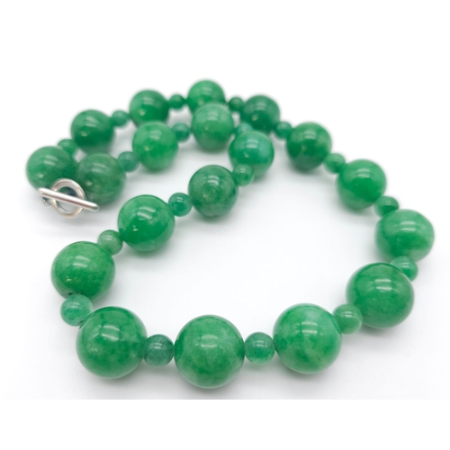 202 - An exquisite large Jade Beaded Necklace.
A mixture of big and small brightly coloured Jade rounded s... 