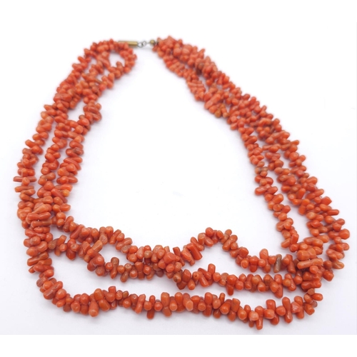 153 - Three Strand Orange Coral Necklace. 
Measuring 42cm in length, this bold necklace is a bright access... 