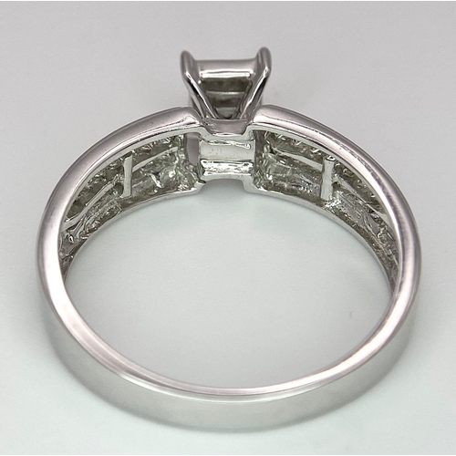 194 - A 14K White Gold Diamond Ring. Nine small central squares with diamond squares on shoulders. 0.50ctw... 