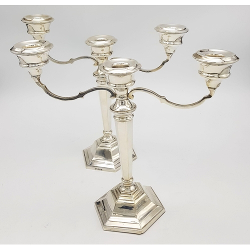 23 - A PAIR OF SILVER CANDELABRA EACH HOLDING 3 CANDLES IN CLASSIC STYLE AND HALLMARKED IN BIRMINGHAM 196... 