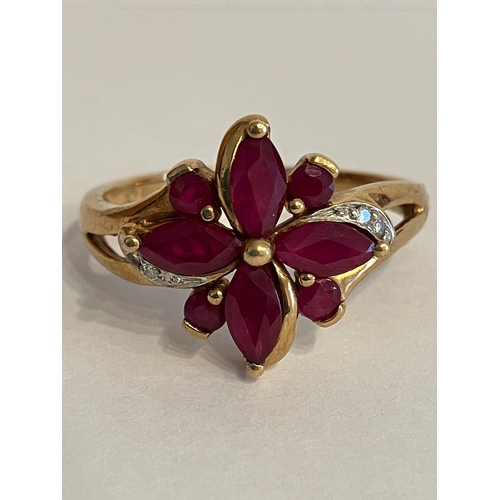 35 - Stunning 9 carat YELLOW GOLD, DIAMOND and RUBY RING. Consisting a cluster of RUBY BAGUETTES with GOL... 