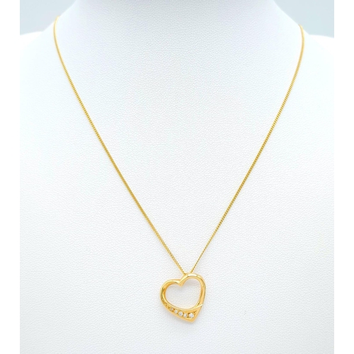 180 - An 18K Yellow Gold Diamond Set Open Heart Pendant on an 18K Yellow Gold Disappearing Necklace. 2cm. ... 