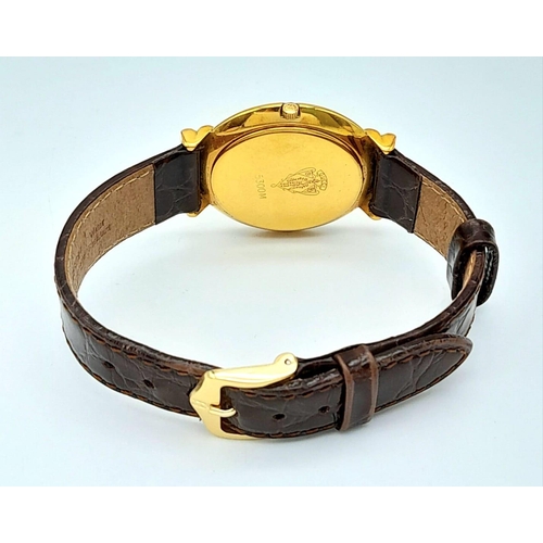 275 - A gold plated GUCCI with crocodile skin strap, case: 33 mm, gold coloured dial and hands, Swiss made... 