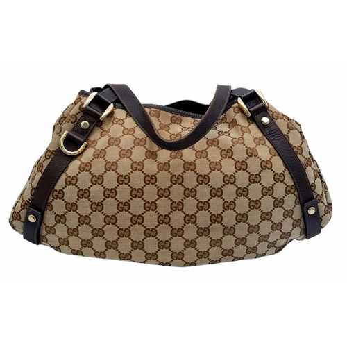 534 - A Gucci Brown Monogram 'Abbey' Shoulder Bag. Canvas exterior with leather trim, gold-toned hardware,... 