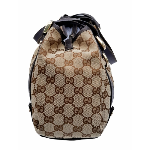 534 - A Gucci Brown Monogram 'Abbey' Shoulder Bag. Canvas exterior with leather trim, gold-toned hardware,... 