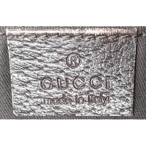 534 - A Gucci Brown Monogram 'Abbey' Shoulder Bag. Canvas exterior with leather trim, gold-toned hardware,... 