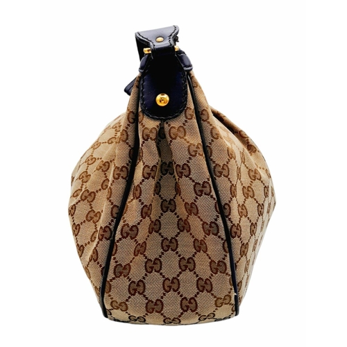 720 - A Gucci Brown Monogram Suki Shoulder Bag. Pleated canvas exterior with leather trim and strap, gold ... 