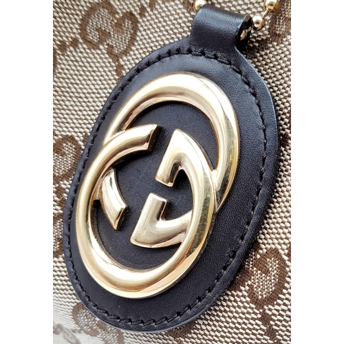 720 - A Gucci Brown Monogram Suki Shoulder Bag. Pleated canvas exterior with leather trim and strap, gold ... 