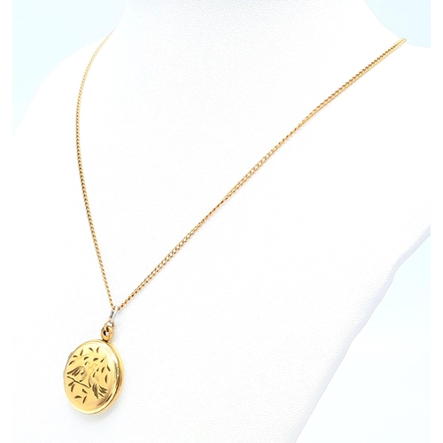 92 - A 9 K yellow gold locket with two loving birds sitting on a branch engraved on the front. With a cha... 