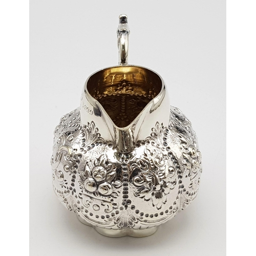 108 - A SMALL SOLID SILVER JUG WITH THE INSCRIPTION 