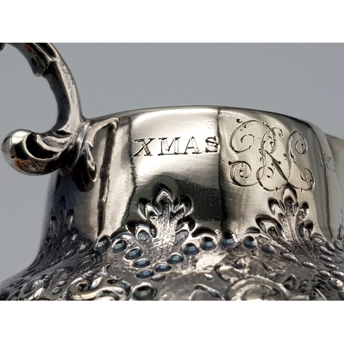 108 - A SMALL SOLID SILVER JUG WITH THE INSCRIPTION 